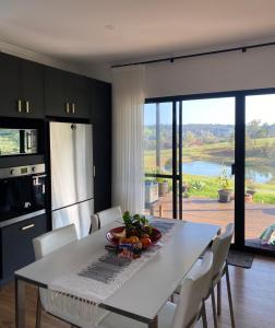 a kitchen with a table and chairs and a large window at Circle of Light Retreat in Kangaroo Gully
