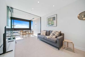 a living room with a couch and a table at Brand new Luxurious 1 Bedroom Perth CBD in Perth +61 photos