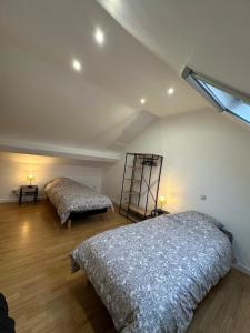 a bedroom with two beds in a attic at THE120 work or holiday home in Comines