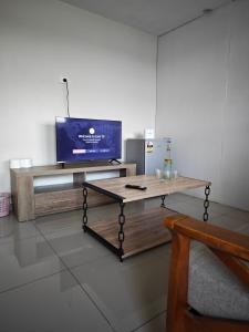 a living room with a tv and a coffee table at Pacific FairPrice One bedroom in Nadi
