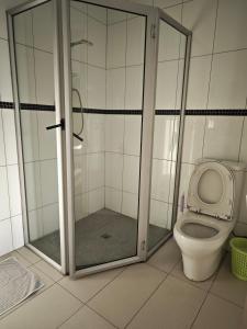 a bathroom with a shower and a toilet at Pacific FairPrice One bedroom in Nadi