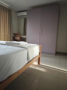 a bedroom with a bed and a cupboard at Pacific FairPrice One bedroom in Nadi