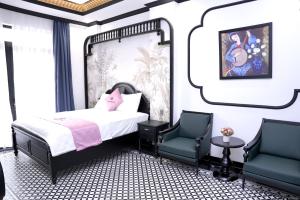 a bedroom with a bed and two chairs at New Pearl Hotel in Ho Chi Minh City +20 photos