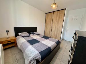 a bedroom with a large bed and a wooden cabinet at Maison 3 chambres avec jardin et spa in Les Arcs sur Argens