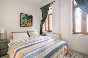 a bedroom with a bed and two windows at House of Soul & Triplex with a Winter Garden in Istanbul