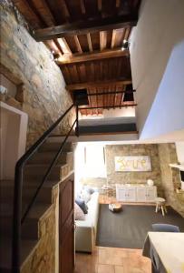 a living room with a couch and a staircase at Nuraghe di mare in La Maddalena