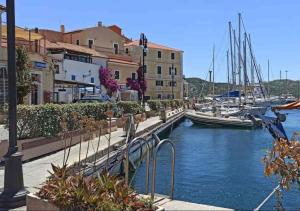 a marina with boats in the water and buildings at Nuraghe di mare in La Maddalena