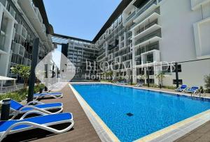 a view of the swimming pool of a apartment building at Bloomfields Pretty Stu in Oasis in Abu Dhabi Intl