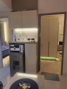eine Küche mit Herd und Arbeitsplatte in der Unterkunft Beautifull Vasanta Innopark Apartment 1BR -MM 2100 Cikarang Bekasi in Jarakasta