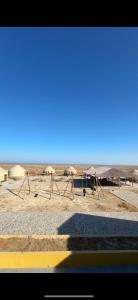a view of a beach with umbrellas and the ocean at Visitor Center Sartas in Ashchimuryn