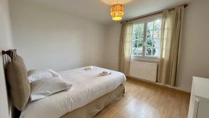 ein kleines Schlafzimmer mit einem Bett und einem Fenster in der Unterkunft Charmante longère - Havre de paix avec jardin et cheminée in Sallenelle