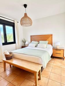 a bedroom with a large bed and a bench at Villa Majanicho Outside con piscina in Majanicho