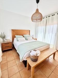 a bedroom with a bed and a table with two baskets at Villa Majanicho Outside con piscina in Majanicho +30 photos
