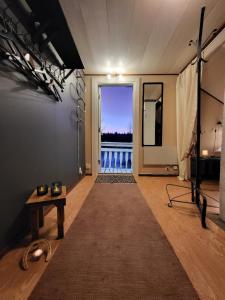 a room with a large window with a view of the ocean at Ainola Arctic Hillside in Rovaniemi