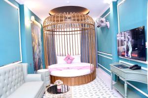 a childs room with a crib in a bird cage at New Pearl Hotel in Ho Chi Minh City
