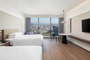 Voodi või voodid majutusasutuse Jieyang Marriott Hotel toas