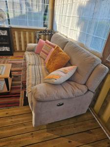 a couch with pillows on it in a room at Mobilehome cosy in Biscarrosse