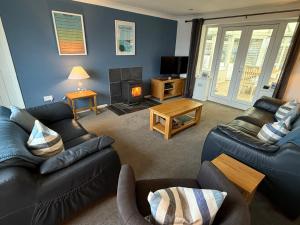 a living room with a couch and a fire place at Rock Point in Salcombe