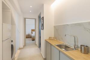 a kitchen with a sink and a counter top at Harma Blue Paros in Ambelas +21 photos