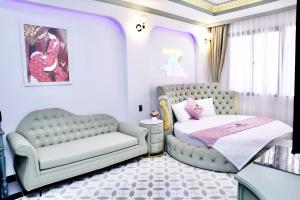 a bedroom with a couch and a bed and a chair at New Pearl Hotel in Ho Chi Minh City