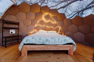 a bedroom with a bed in a hexagonal wall at les bulles perchées de lartigue in Margouët-Meymès +13 photos