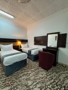 Postel nebo postele na pokoji v ubytování Eqamh Etlala Quba- إقامة إطلالة قباء