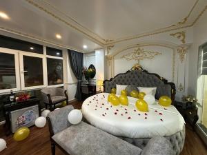a bedroom with a large bed with yellow balloons on it at Aloha Hotel in Hanoi