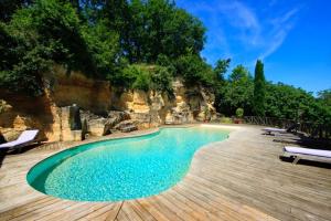 a swimming pool with chairs and a wooden deck at Domaine de Pertignas in Saint-Vincent-de-Pertignas +18 photos