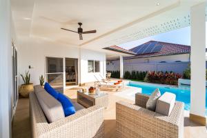 a living room with a pool and a ceiling fan at New Modern 3 Bedroom Pool Villa - MB3 in Hua Hin