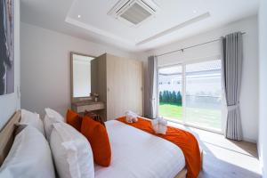 a bedroom with a large bed and a large window at New Modern 3 Bedroom Pool Villa - MB3 in Hua Hin +48 photos
