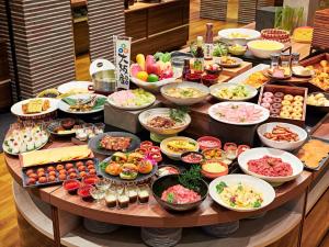 a table with many plates of food on it at APA Hotel & Resort Osaka Namba Ekimae Tower in Osaka