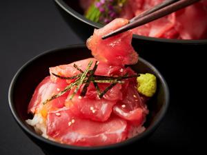 a bowl of meat and rice with chopsticks in it at APA Hotel & Resort Osaka Namba Ekimae Tower in Osaka