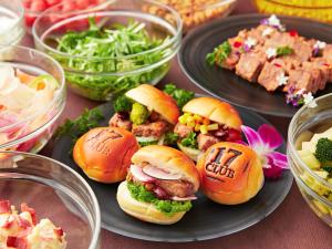 a table topped with plates of food with sandwiches and vegetables at APA Hotel & Resort Osaka Namba Ekimae Tower in Osaka