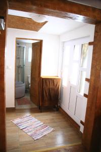 a bathroom with a sink and a toilet in a room at Cabana Bunicilor in Răchiţele