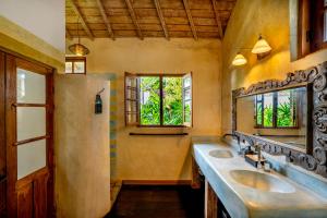 a bathroom with two sinks and a mirror at Villa Amsa - Tropical Paradise in Seminyak Center in Seminyak +18 photos