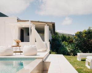 a villa with a swimming pool and a house at Principe Di Salina Boutique Hotel in Malfa