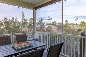 a table and chairs on a balcony with views of the ocean at The Rookery III 5008 cottage in Gulf Shores