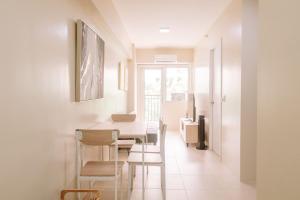 a dining room with a table and chairs at Pool Garden Tranquility in Iloilo City