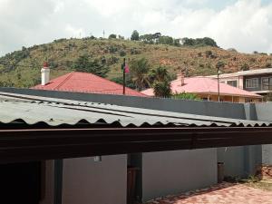 a roof of a house with a hill in the background at Johannesburg guest house Kensington in Johannesburg