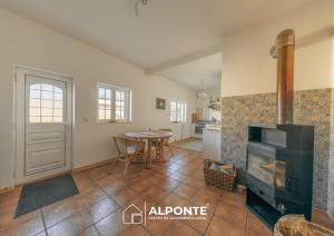 a living room with a fireplace and a table at Casa da Melanie in Caminha
