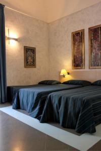 Кровать или кровати в номере Archimede Vacanze B&B