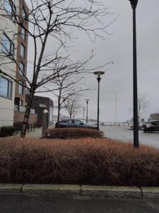 a car parked in a parking lot next to a building at Mulka Sandnes Room in Sandnes