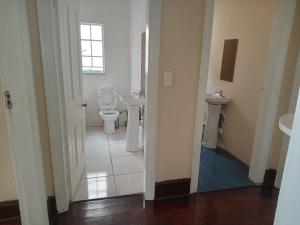 a bathroom with two sinks and a toilet at Johannesburg guest house Kensington in Johannesburg +63 photos