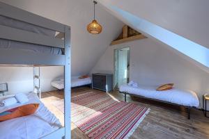 a bedroom with two bunk beds and a mirror at Le Charme de L'ancien - A 6km de la Trinité sur Mer in Crach