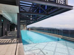 a swimming pool on the roof of a building at MOSSAZ Minimalist Studio 2 in Petaling Jaya