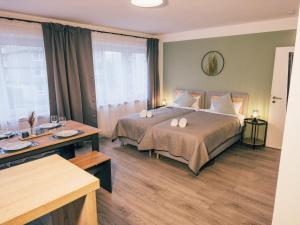 a hotel room with a large bed and a desk at ImmoStay City Apartments - Modern & WiFi in Bremen
