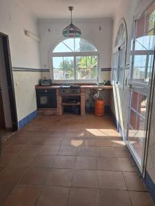 an empty kitchen with a large window and a counter at Casa maravillosas vistas in Motril +9 photos