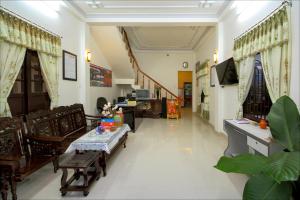 a living room with a couch and a table at Blue Lake Homestay in Hoi An