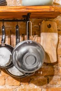 a strainer and a frying pan hanging on a wall at House of Soul & Triplex with a Winter Garden in Istanbul