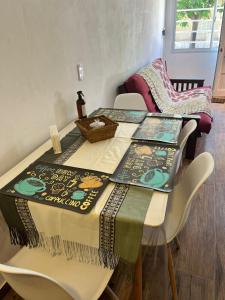 a table with a table cloth on it with chairs at Shanti Loft in Concepción del Uruguay +14 photos